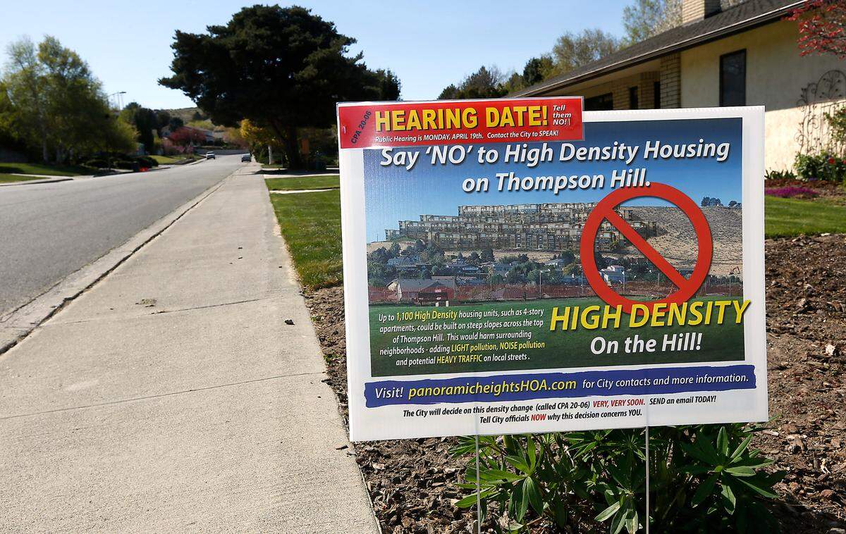 A sign created by The Panoramic Heights Homeowners Association in 2021 was posted in the front yard of a home in the Kennewick housing development in opposition to the proposed high density residential development of about 40 acres along the top of Thompson Hill. The yard signs depicts the proposed area with a photo of apartment buildings added to the hillside.