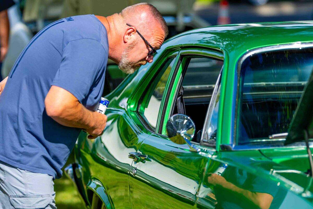 A spectator examines the interior of a restored classic car Saturday during the Show N Shine at Cool Desert Nights in Richland. Hundreds of classic vehicles filled the Uptown Shopping Center during the annual community event.