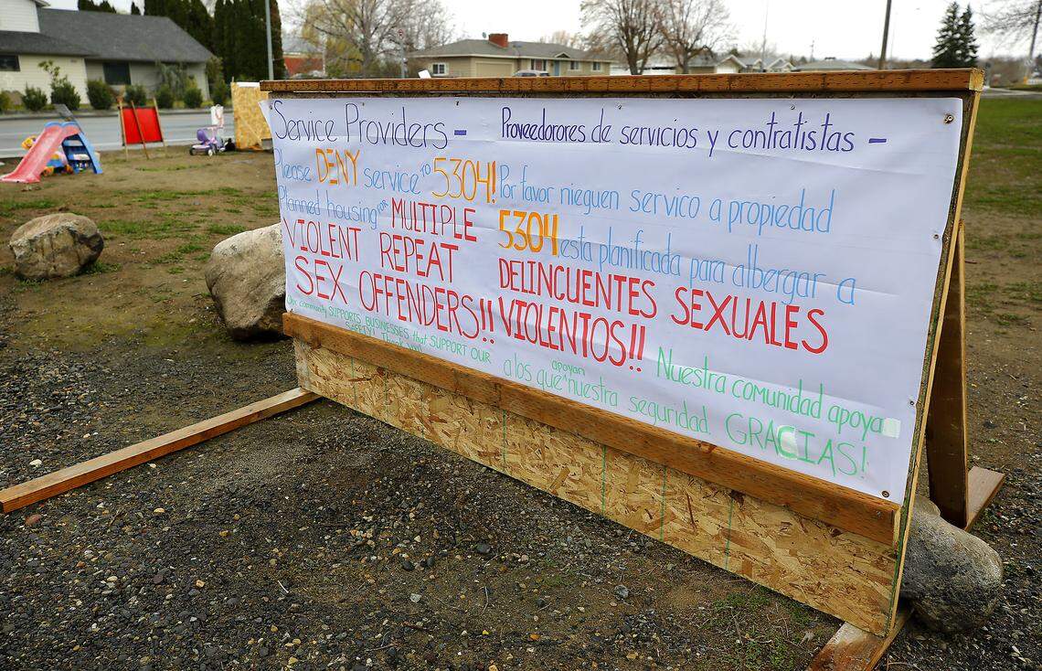 Neighbors in the area off West Eighth Avenue have placed signs, various children's toys and stuffed animals along Edison Street in Kennewick opposing the decision to allow a home for sex offenders. 