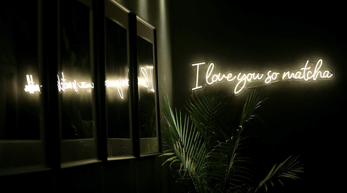 The decor of the cafe is dark concrete mixed with bright, neon lights creating a comforting atmosphere.