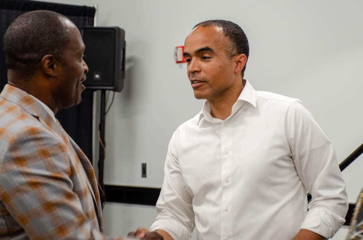 Washington Attorney General Nick Brown, right, meets with Tri-Cities NAACP Chapter President Irving Brown Sr. after a Monday town hall.
