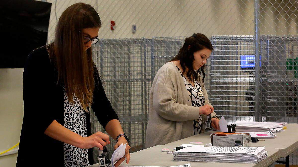 Benton elections employees Amanda Hatfield, left, and Grace Davidson, date stamp three boxes of signed recall petition papers delivered by Richland residents to the Benton County Elections Center.