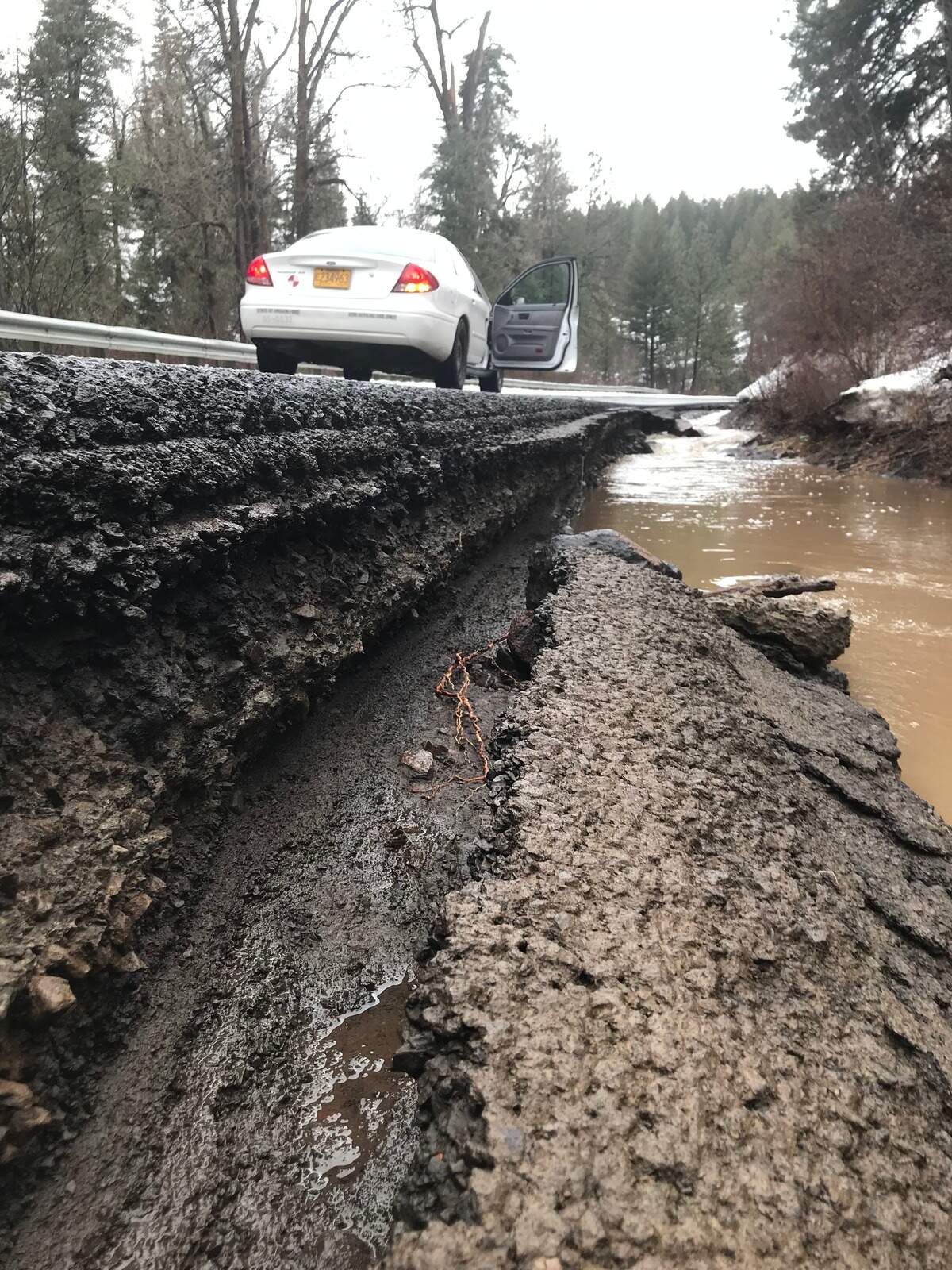 The shoulder of Oregon Highway 204 has been eroded away because of flooding.