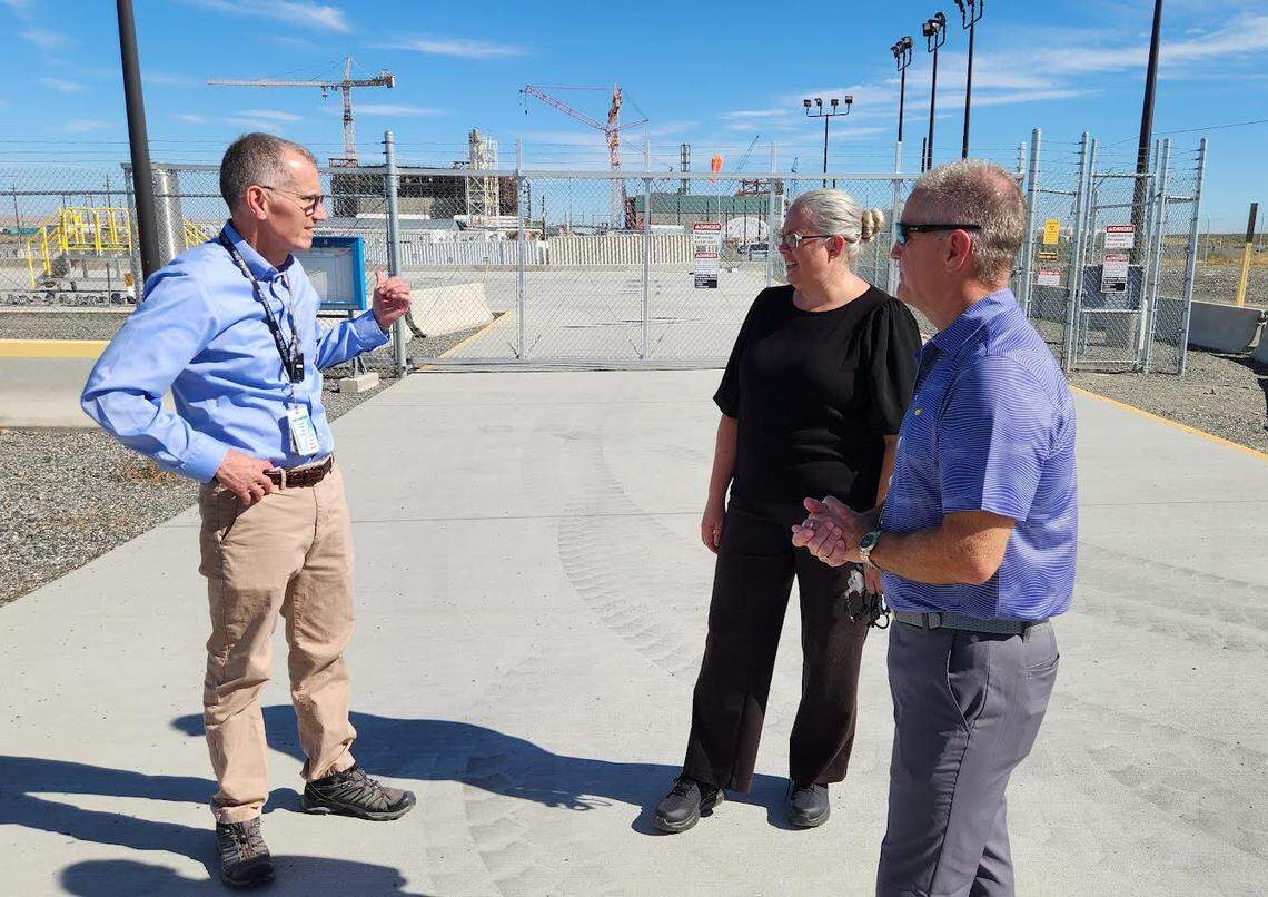 Candice Robertson, Department of Energy senior adviser for environmental management, talks with DOE Hanford Manager Brian Vance (left) and Washington River Protection Solutions President Wes Bryan (right) outside the Tank Side Cesium Removal complex at the Hanford Site.