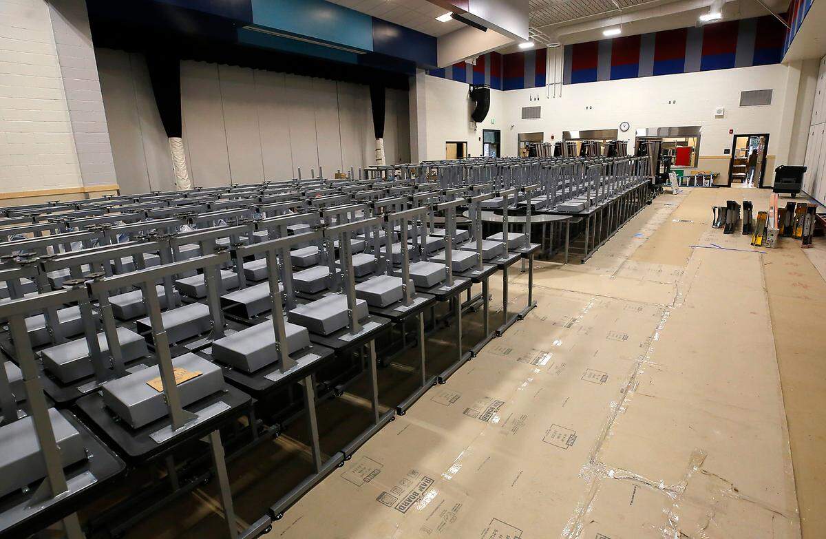 Dozens of student desks are staged in the cafeteria at the new Ridge View Elementary School building.