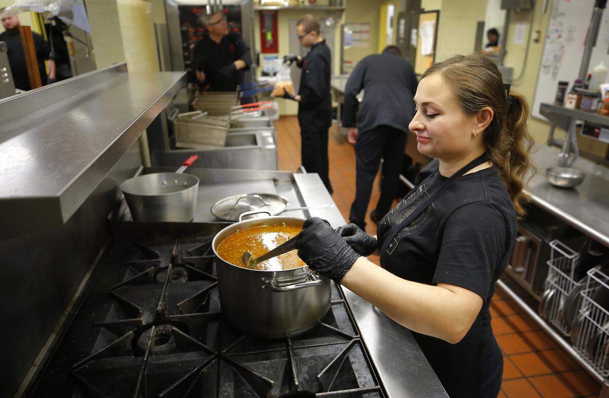 Staff member Natalia Kondratkaia stirs in seasoning she added to a pot of Borscht soup she was making at the Opportunity Kitchen in a restaurant space at the Federal Building in Richland. She is a graduate of the program operated by Columbia Ability Alliance.