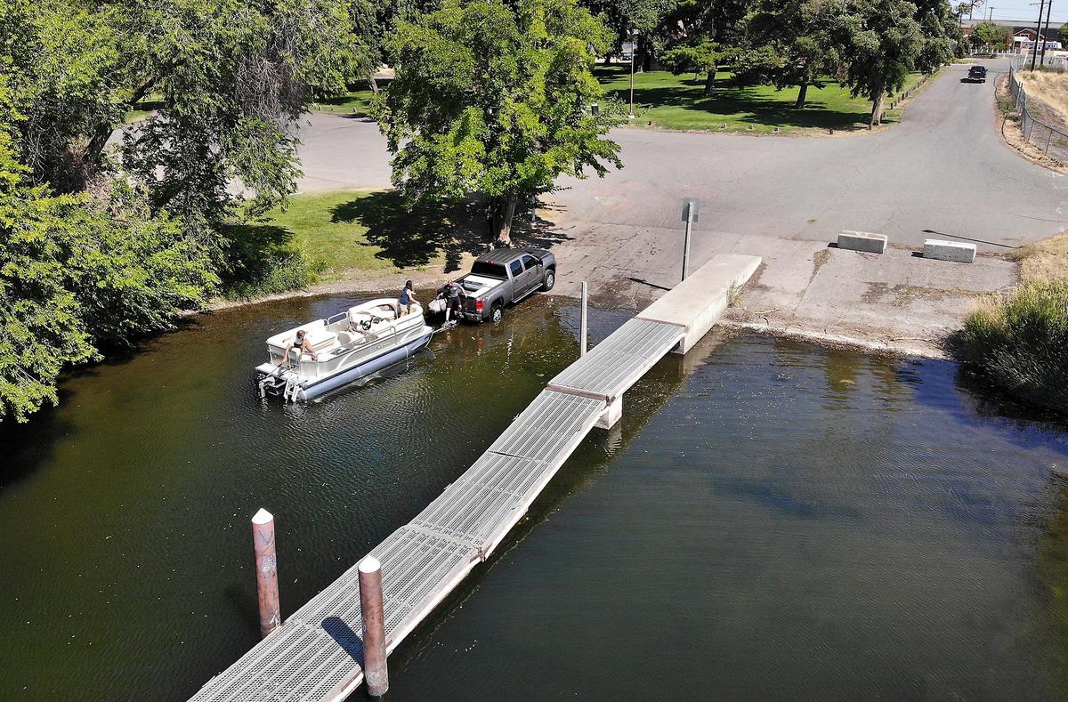 Dustin Mager of Northwest Marine and Sport in Pasco climbs aboard with customers Rob and Marla Hensel for a test ride Wednesday of a pontoon boat they purchased for a small lake near their home in Duvall at the Schlagel Park boat launch in Pasco. The city of Pasco recently received a $661,000 state grant to make improvements at the facility on the Columbia River. The existing launch was built by the U.S. Army Corps of Engineers in the 1950s. The city is contributing $235,000 to the project to upgrade the launch boarding floats, concrete ramps, parking area and to replace the restroom. building Watch a video at: tricityherald.com