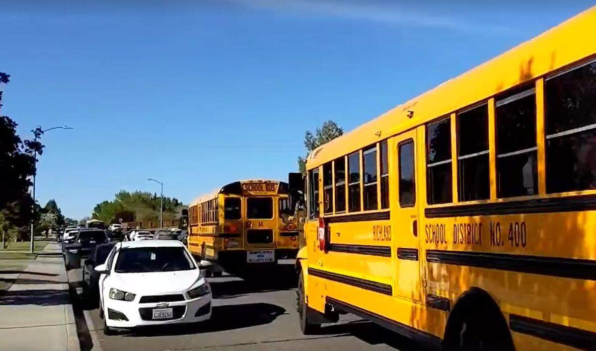 Richland School District sent buses in to transport children to their parents waiting at a reunification area after a woman was killed outside of William Wiley Elementary in West Richland on Monday.