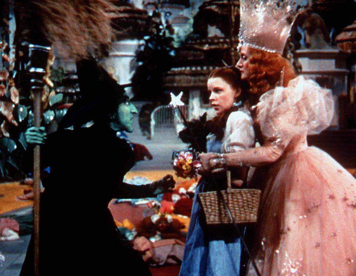 The Wicked Witch of the West, left, played by Margaret Hamilton, confronts Dorothy, played by Judy Garland, and Glinda, the Witch of the North, played by Billie Burke, right, in this scene from ‘The Wizard of Oz.’