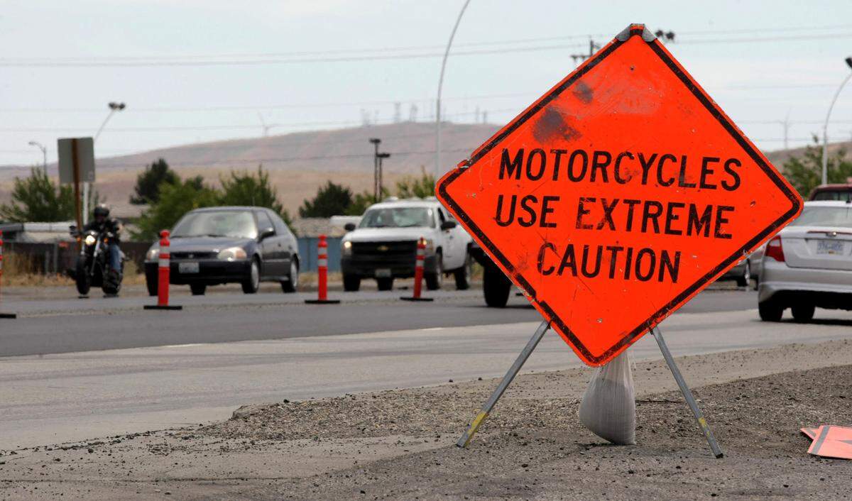 A highway warning sign urges extra caution for motorcyclists driving through a construction zone in Kennewick. 