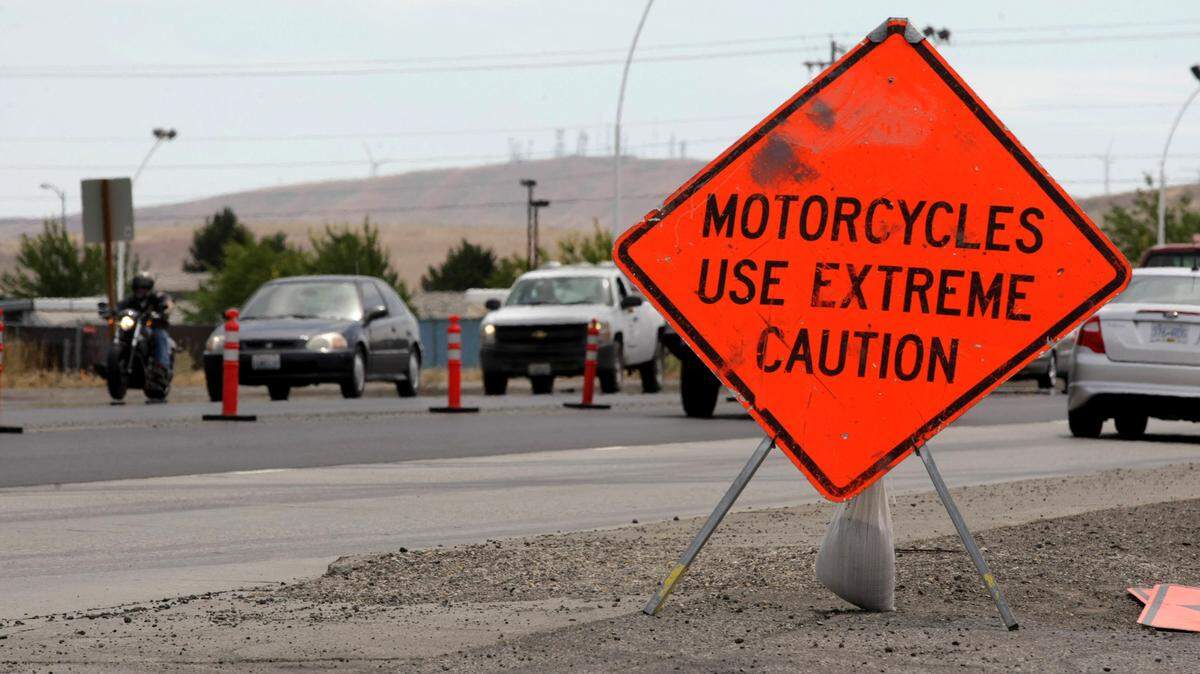 A highway warning sign urges extra caution for motorcyclists driving through a construction zone in Kennewick. 