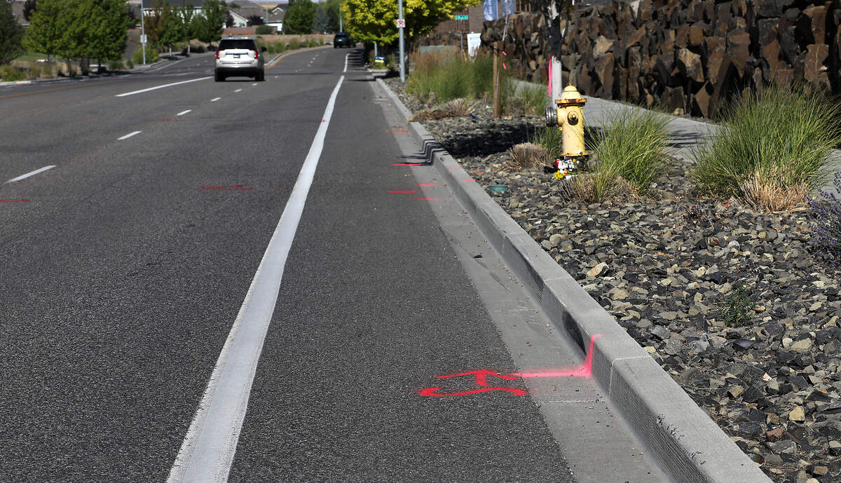 A memorial has been placed to honor the motorcyclist who died Friday night in a crash on West Hildebrand Boulevard. The paint on the curb is part of the police investigation.