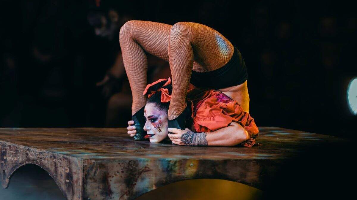 A contortionist on stage with Paranormal Cirque, the horror-themed circus returning to Tri-Cities.