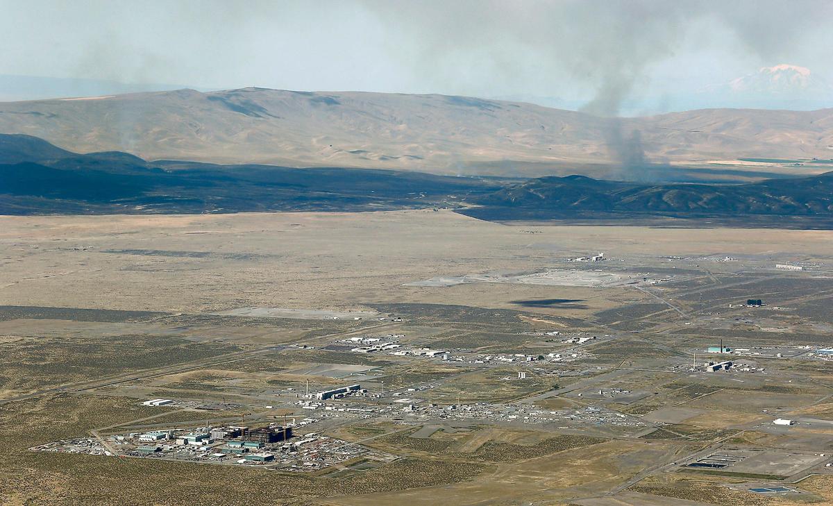 Several plumes of smoke from active fire rise into the air from the fire charred landscape of the Cold Creek wildfire in the summer of 2019 near the Hanford site near Richland. The nuclear waste vitrification plant, still under construction, is visible in the lower left corner of this aerial photo taken from an altitude of about 4,000 feet. Mount Rainier is faintly visible through the smoky haze in the upper right corner.