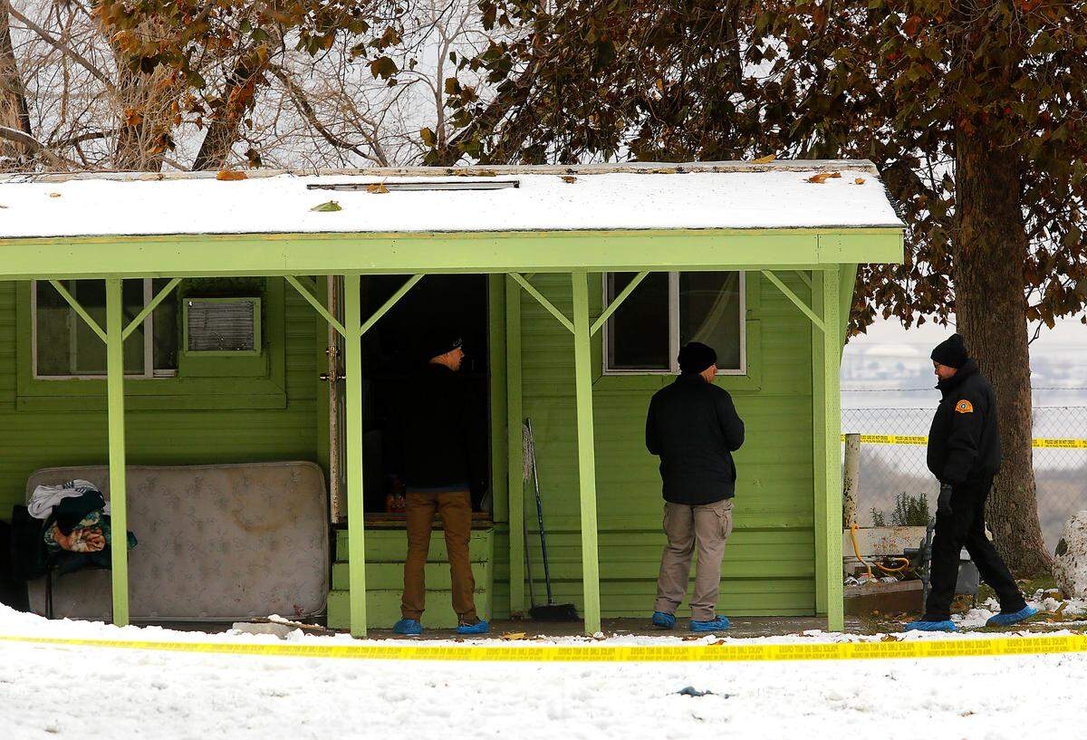 Members of the Washington State Patrol Crime Lab crime scene unit gather and document evidence from the trailer that’s part of the scene of an officer-involved shooting at the Lakeview Manufactured Home Community in east Pasco.