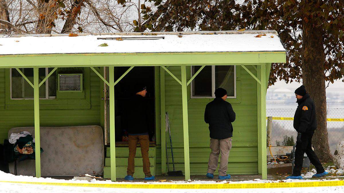 Members of the Washington State Patrol Crime Lab crime scene unit gather and document evidence from the trailer that was part of the scene of an officer-involved shooting at the Lakeview Manufactured Home Community in east Pasco in December.