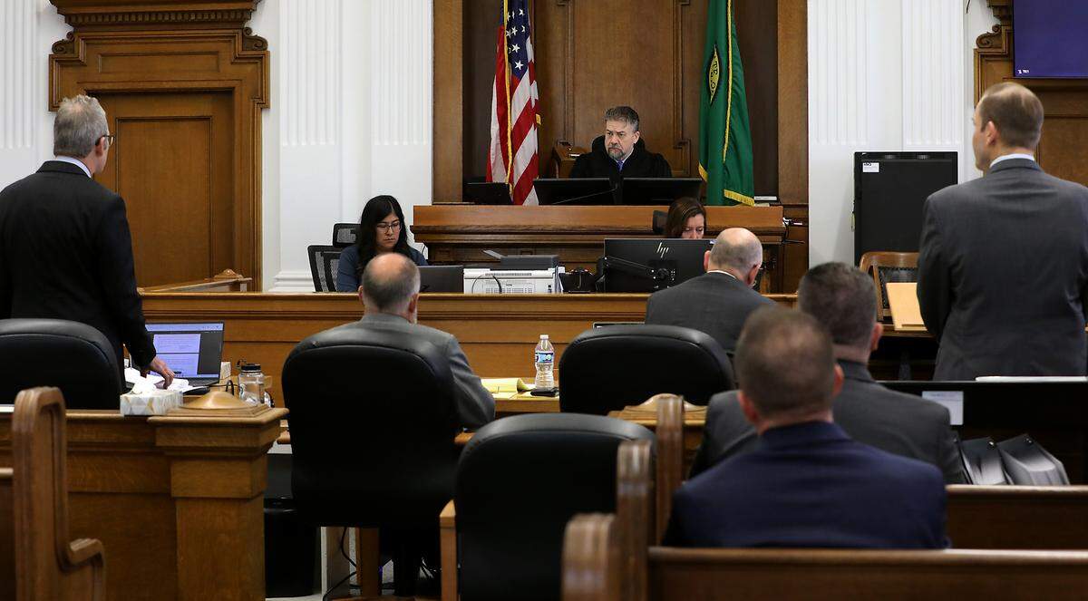 Superior Court Judge Brandon Johnson listens to motions by Benton County attorney Andrew Cooley, left, and plaintiff attorney Eron Cannon.