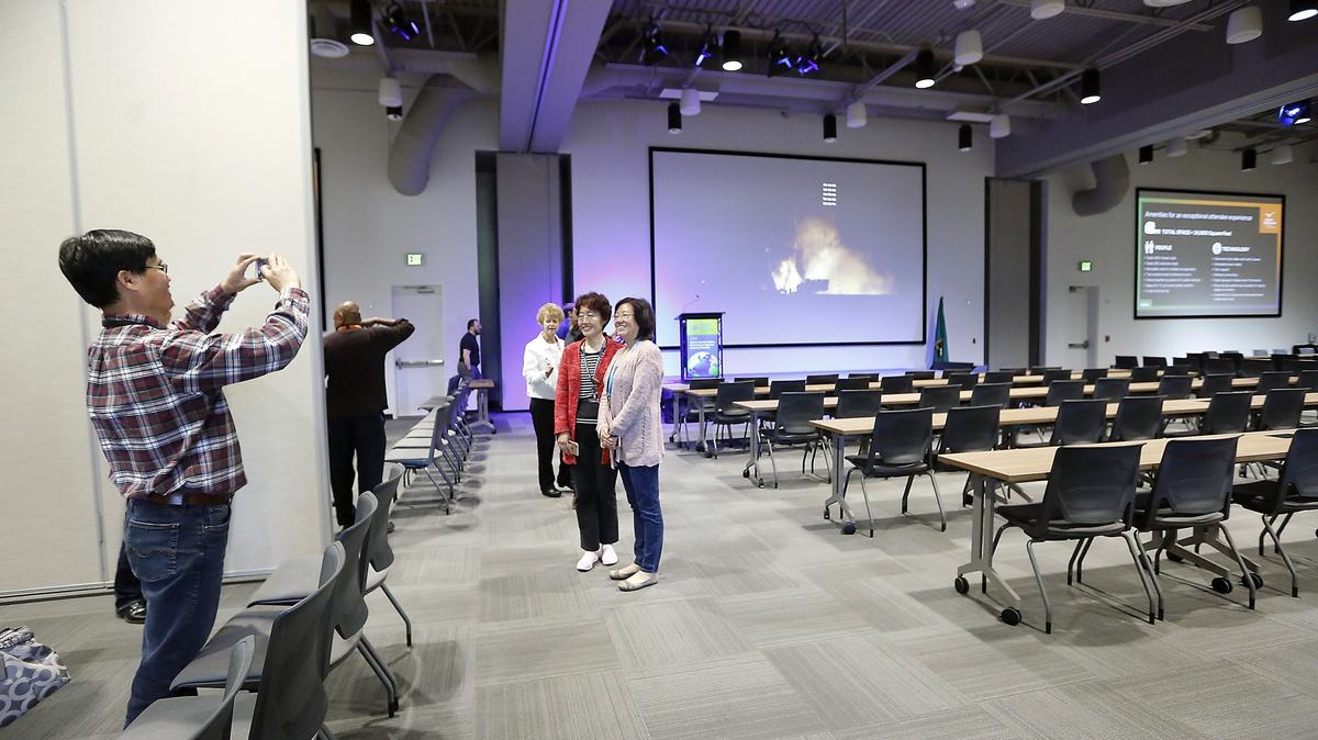 Pacific Northwest National Laboratory employees and other visitors pause for photos during a tour Monday morning at the new $9.8 million Discovery Hall at the Richland research facility. Officials held a ribbon cutting ceremony for the new 24,000-square-foot building offers 456 theater style seating, 262 classroom seats, movable walls, smaller conference rooms, deli food service and state-of-the-art digital and audiovisual capabilities.