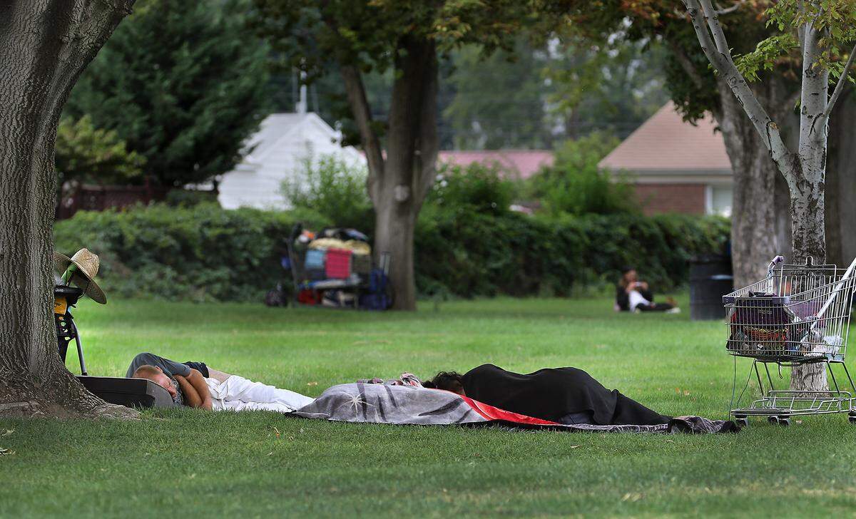 The homeless sleep on the ground under the trees recently at Yelm Park in Kennewick.