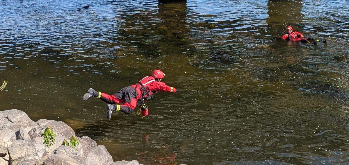 A Benton County Fire District 4 firefighter jumps into the Yakima River Thursday to practice a water rescue.