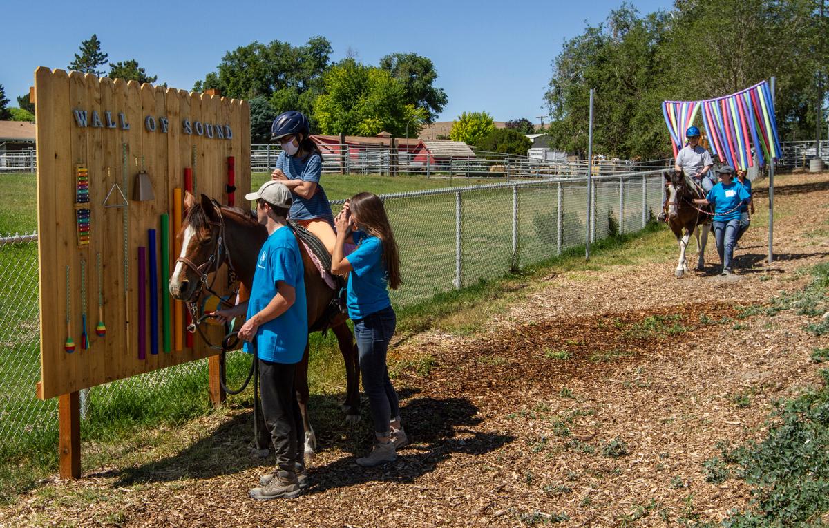 Therapeutic Riding of Tri-Cities (TROT) participants and volunteers try out the Happy Trails Sensory Course in June 2021.