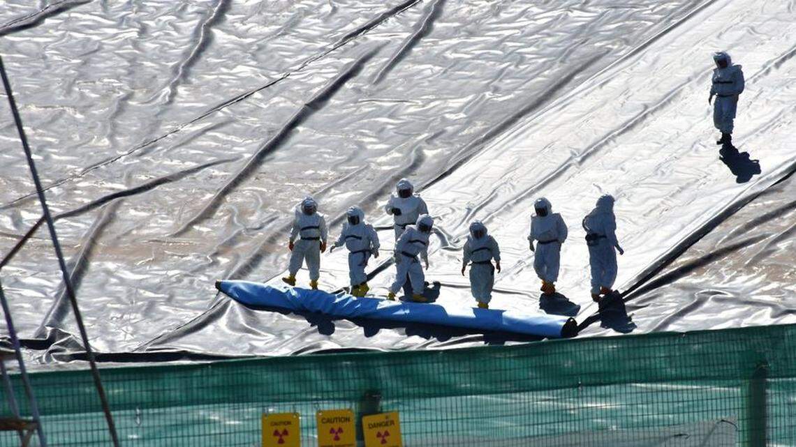 The Silent Majority Foundation is considering a class action lawsuit over the COVID vaccine mandate for Hanford workers. Hanford workers are shown installing a new cover on site waste basin.