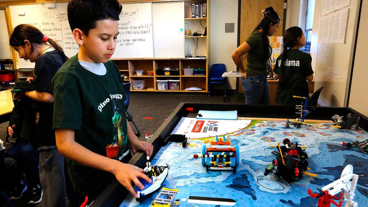 Fourth-grade student Sergio Preciado of Richland demonstrates how the Lego robot he helped write code for works on the “Submerged” themed task board.