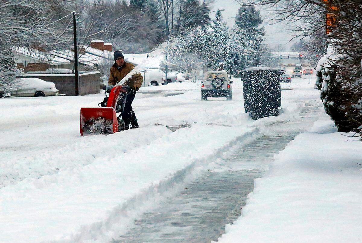 Snow flies from the chute of snowblower early Thursday morning as a Kennewick resident on South Kellogg Street clears the overnight snowfall from the side of the street, sidewalk and driveway of a home near West Fifth Avenue.