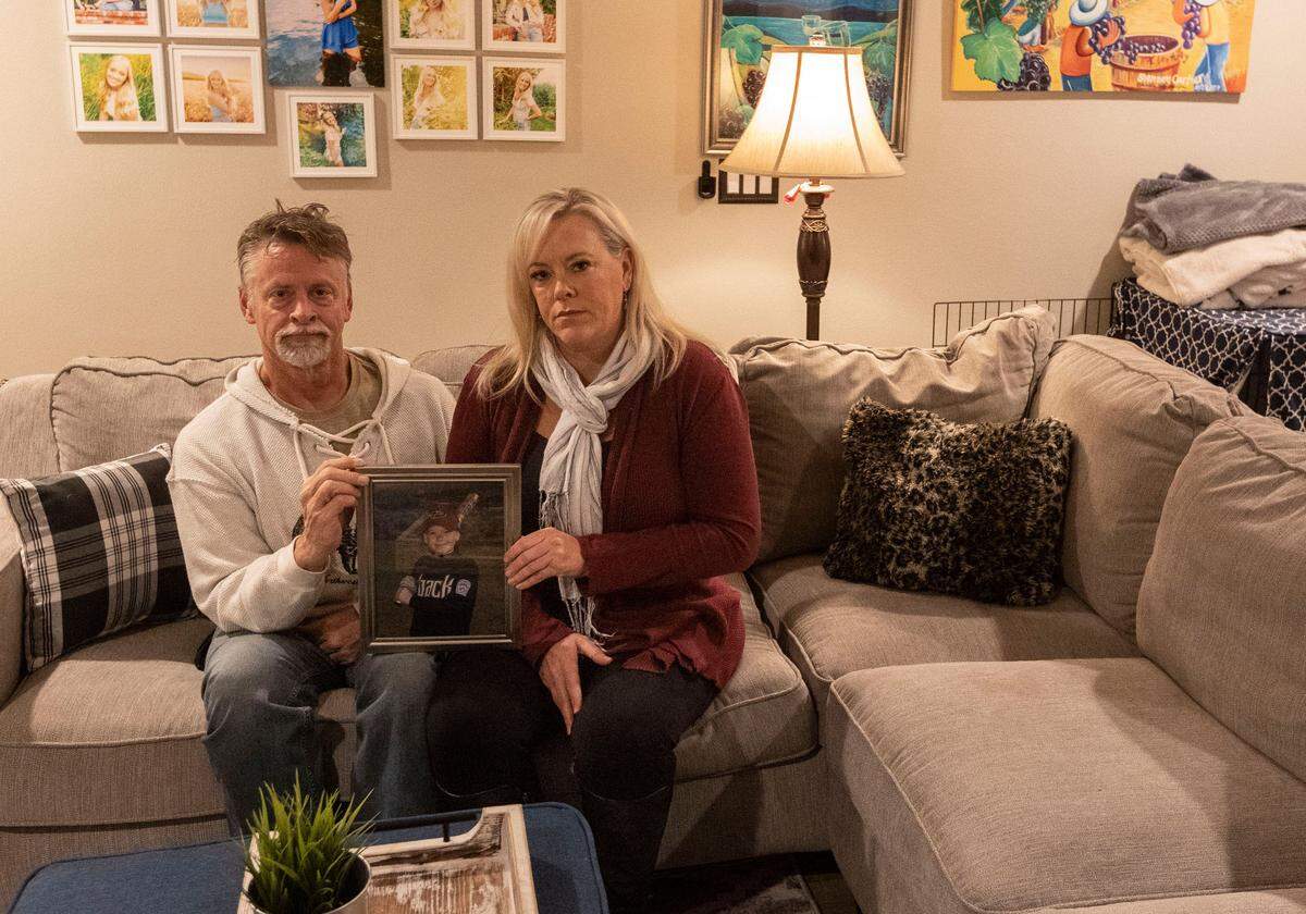 Curt and Shannon Cartier hold a picture of their son, Cannon, when he was younger. He was one of more than 100,000 in the United States who died of drug overdoses in 2021. “Our son is a statistic ... but he had a story, he had a life, he had people who loved him and the ripple effect of his death, the concentric circles are still spreading out across the globe and they will be for the rest of our lives,” Curt said.