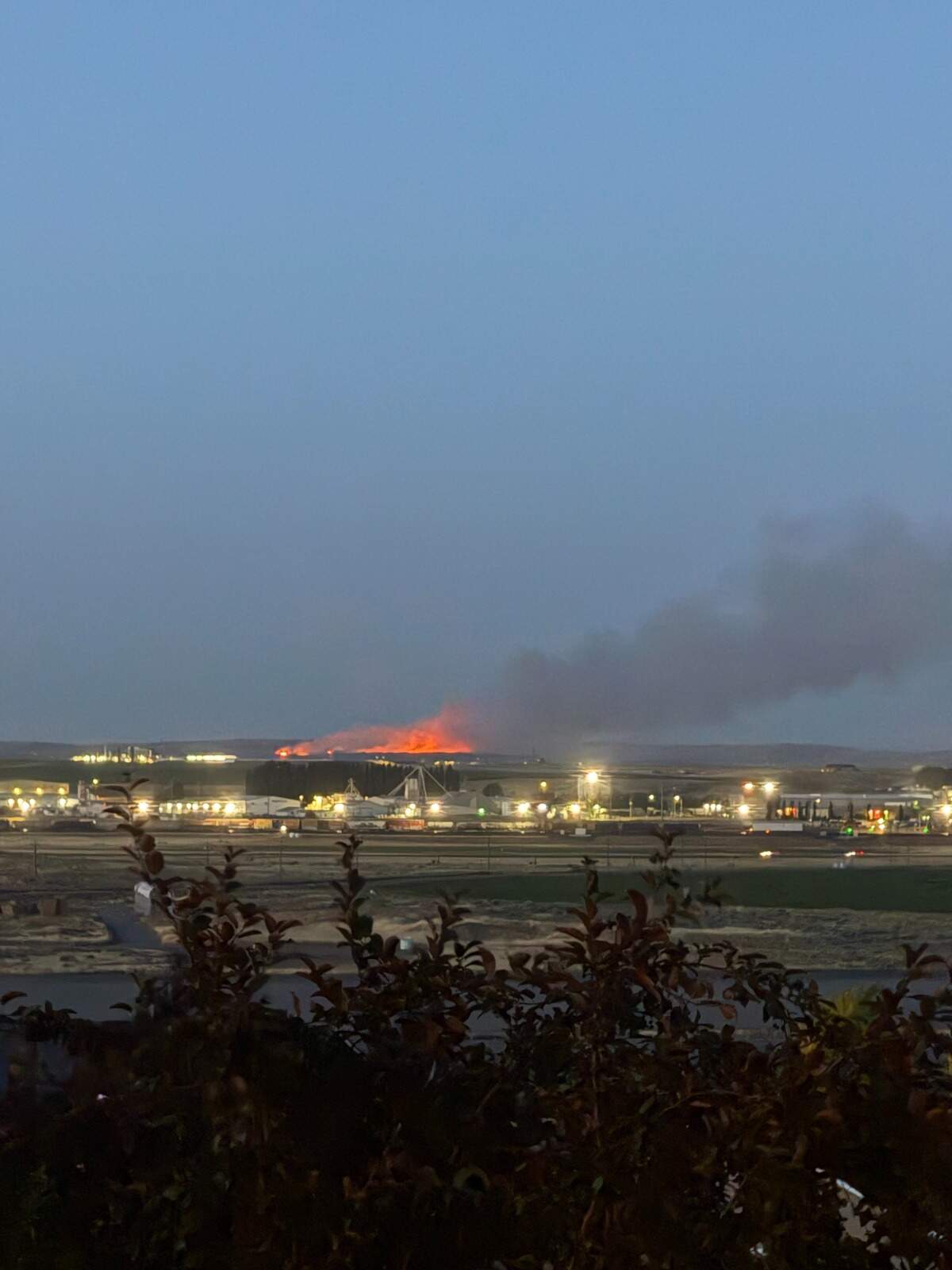 Tri-City area fire crews are still battling a wildland fire at Juniper Dunes that started Saturday.