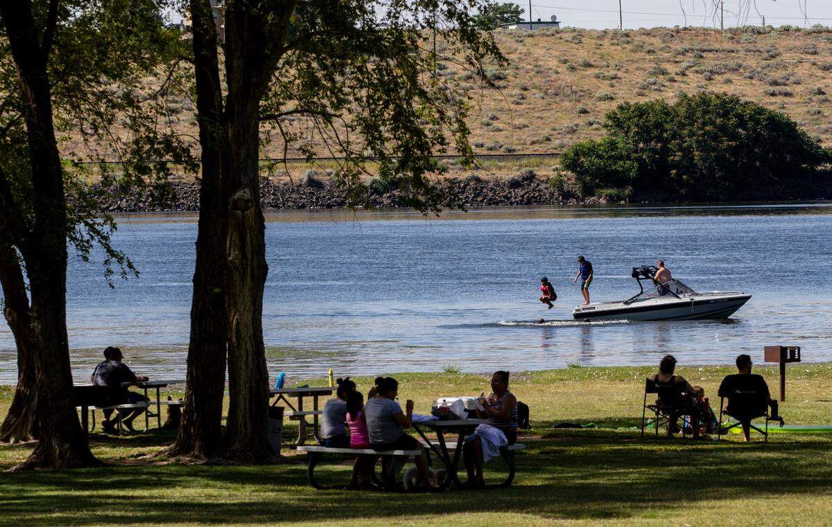 People beat the heat in Hood Park along the Snake River.