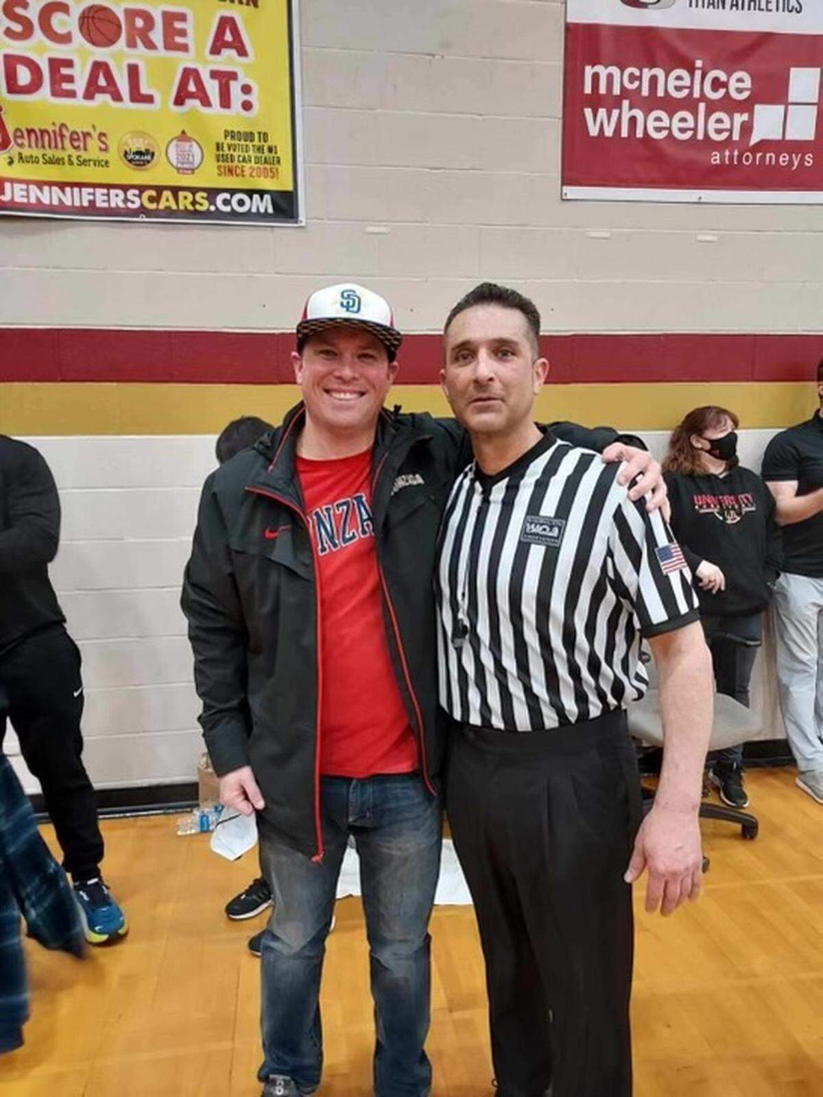 Kyle Perkins, left, poses for a photo with longtime basketball referee Tony Wise, who is fighting cancer.