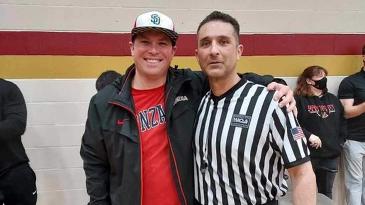 Friend Kyle Perkins poses for a photo with referee Tony Wise, who recently died from cancer.
