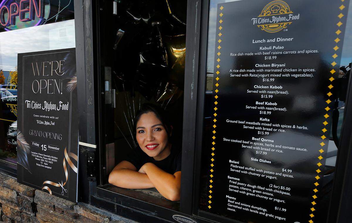 Tri-Cities Afghan Food co-owner Amina Hussaini Mohammad looks out the order window on Nov. 15 at the Pasco Specialty Kitchen, the commercial kitchen incubator in downtown, 110 S. Fourth Ave. It serves Afghan-inspired dishes such as savory kababs and spices rice dishes. It is led by husband and wife team Ghulam Sakhi Mirza Mohammad and Amina Hussaini Mohammad.