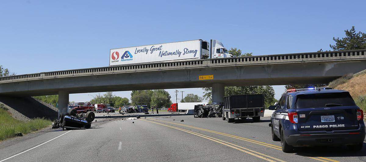 Washington State Patrol troopers and Pasco Police department investigate the scene of Thursday's double fatal collision at the Lewis Street exit on Highway 395.