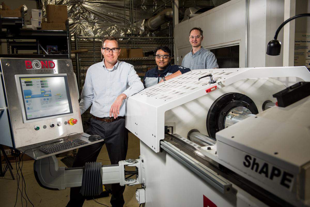 PNNL researchers including Jens Darsell, Vineet Joshi and Scott Whalen (from left) are using a new process that offers a novel way to manufacture wire, bar, and tubular extrusions with unprecedented improvements in material properties. For example, their approach could make it more feasible for the auto industry to incorporate lightweight magnesium alloys into structural components.