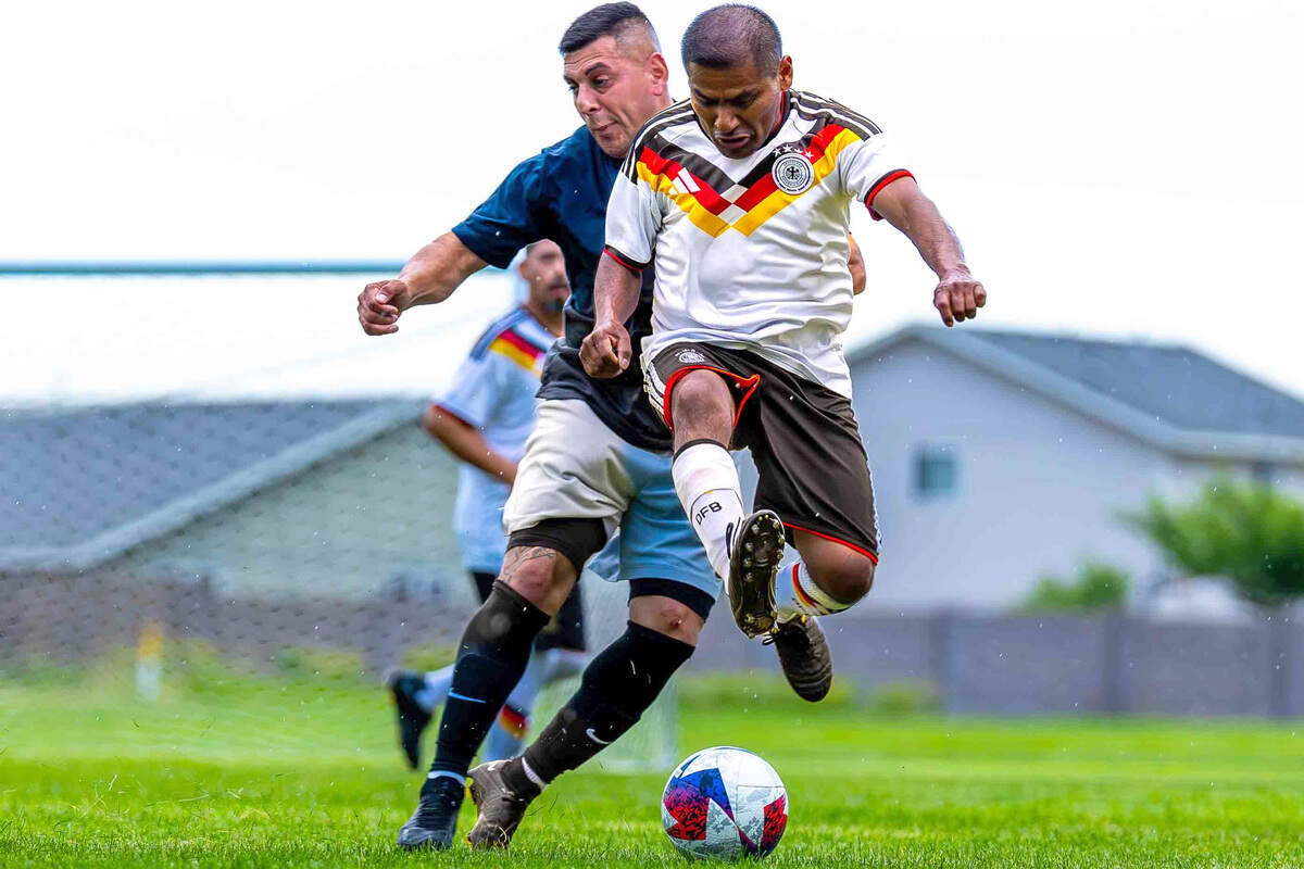 Alfredo Herrera, right, of Tercer Tiempo FC leaps for the ball ahead of Julio Meralez of the black team during a La Liga 1020 Division Championship soccer match on May 28 at the Tri-City Soccer Association Soccer Complex in Pasco.