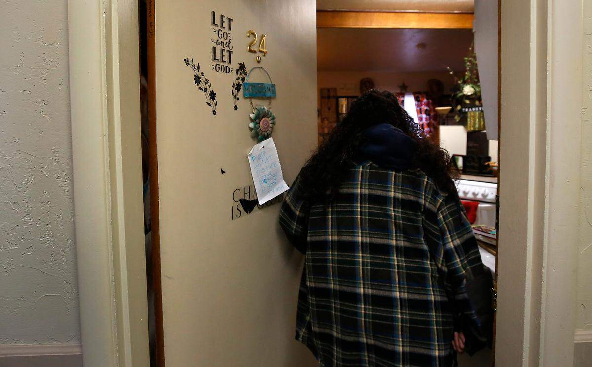 Diane Alaniz Anzar displays meaningful decorations on the door to her supportive housing studio apartment in downtown Kennewick. She is celebrating over two years being sober and is about to make the transition to an apartment of her own.