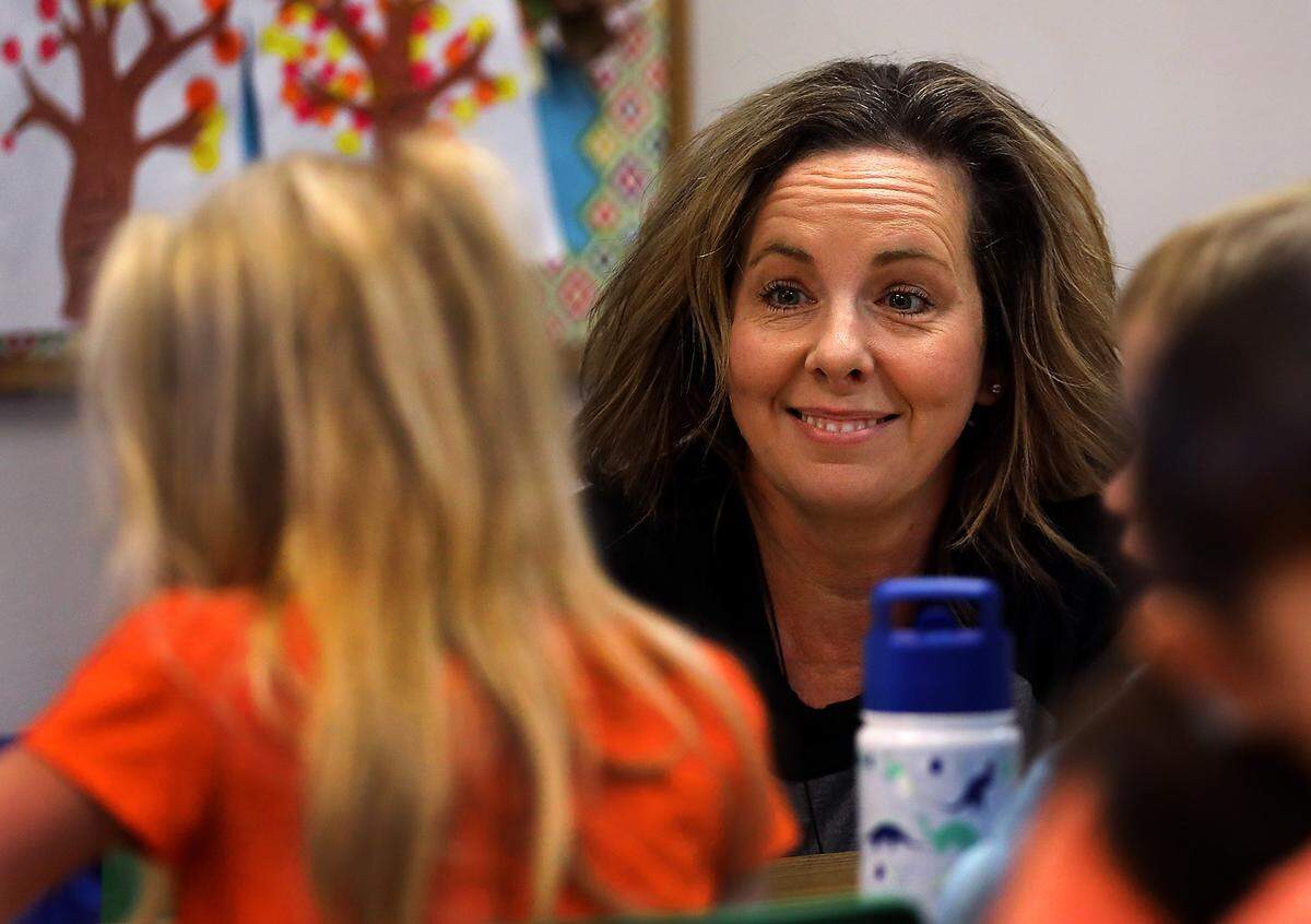 Leslie Hieb, owner of Level Up Learning preschool in Kennewick, smiles while talking with students enrolled in the facility’s full-time program.