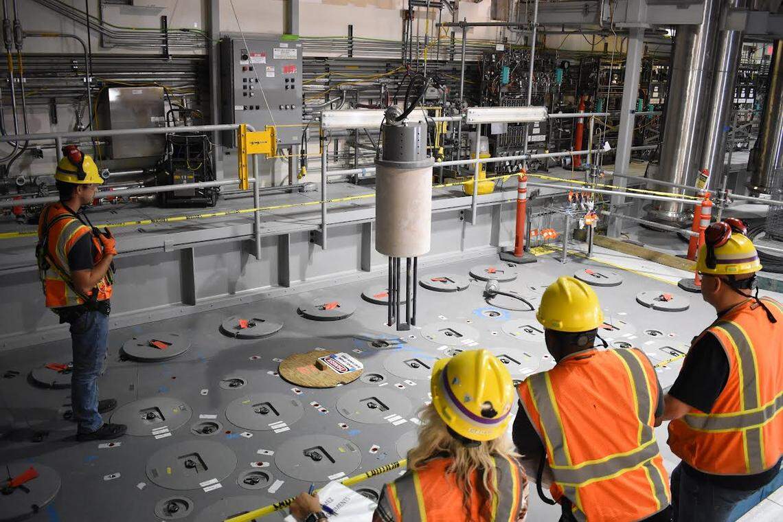A Hanford vitrification plant crew installs one of 18 startup heaters into the lid of the first melter to begin to be heated up inside the Low Activity Waste Facility.