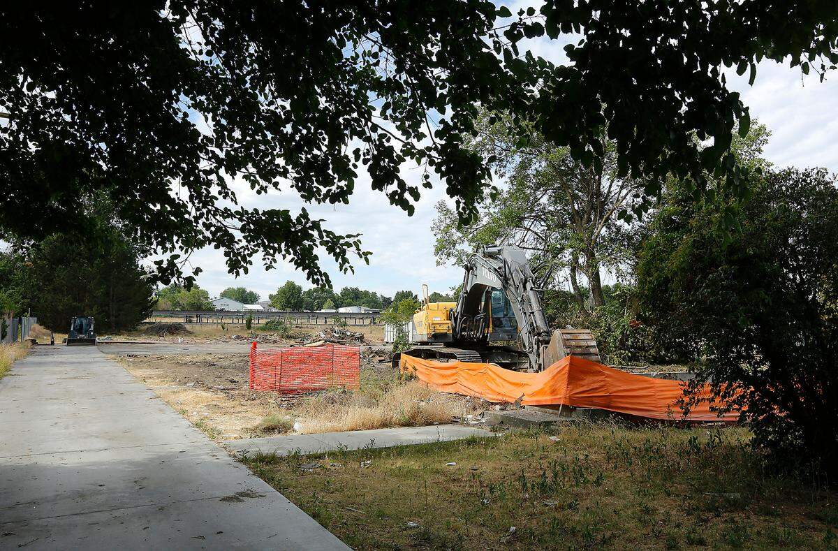 Equipment for cleanup and demolition sits idle on two acres of land at 911 W. Entiat Ave. recently in Kennewick. City building permit records indicate a complex of six buildings with 36 new townhouses are planned for the site that previously had a single family home and some out buildings.