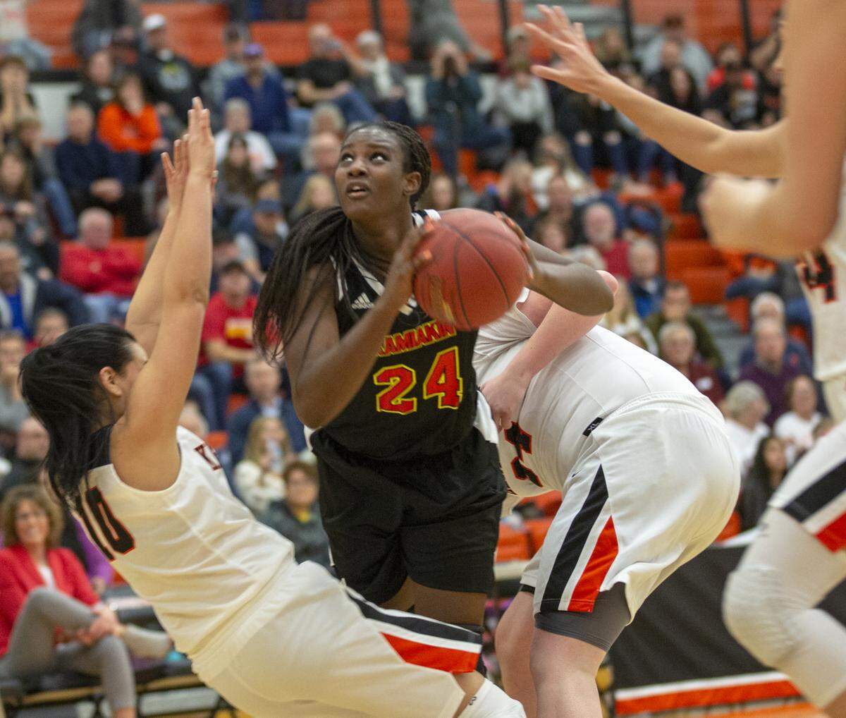 Kamiakin’s Oumou Toure (24) attempts to shoot the ball while being surrounded by Kennewick’s defense during a recent game at Kennewick.