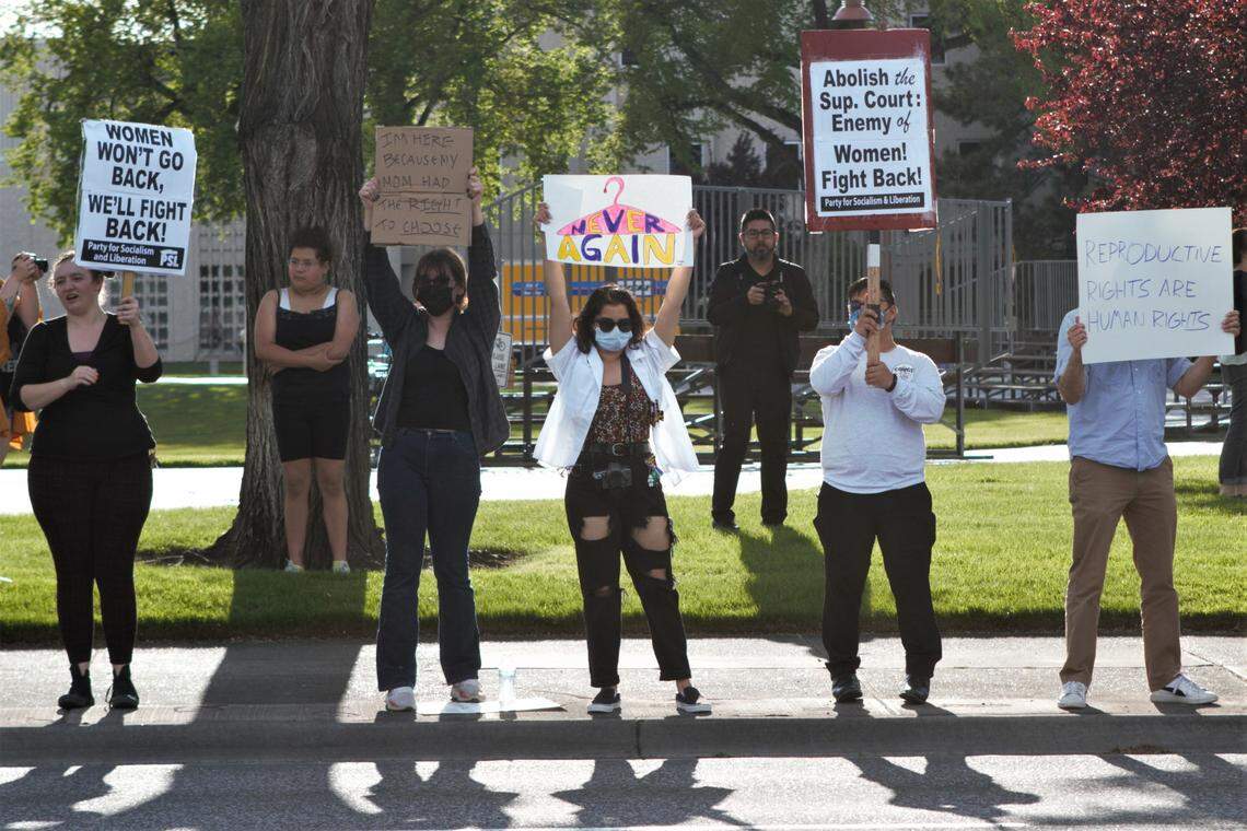 A protester holds a sign that reads, “Never Again” in reference to the deaths of women trying to obtain an abortion before the landmark Roe v. Wade decision.