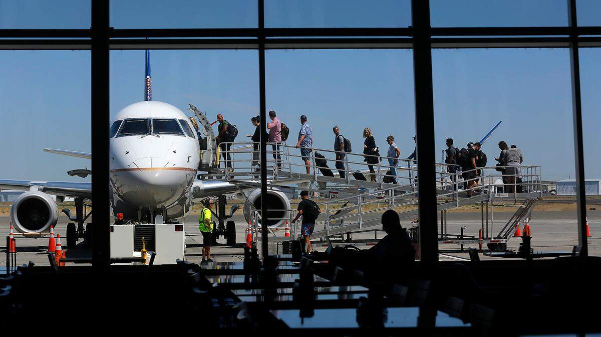 Passengers board a departing United Express jet at the Tri-Cities Airport in Pasco.