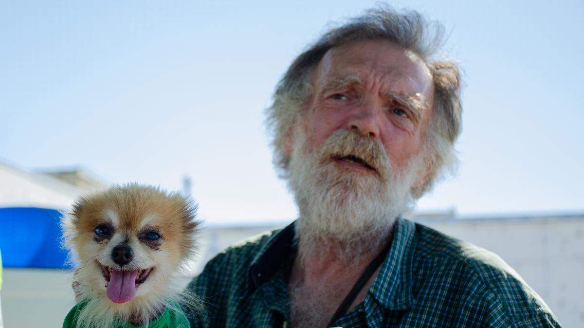 Doug Barnes sits with his 13-year-old pomchi mix, Macky Rae, on a hot afternoon in downtown Pasco. The once-homeless U.S. Air Force veteran is an advocate for Clean Sweep handing out water bottles to the homeless.