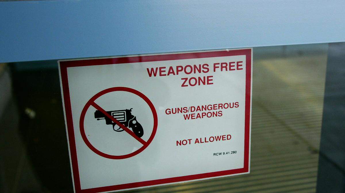 A sign on the main entrance of a Tri-Cities High School references the Revised Code of Washington that makes all schools in the state of Washington off-limits to weapons. Washington lawmakers are now expanding that prohibition to zoos, aquariums, libraries and transit stations.