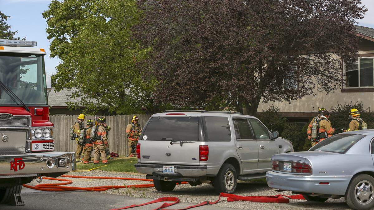Firefighters work to put out a fire along North Fillmore Place in Kennewick. No one was hurt.