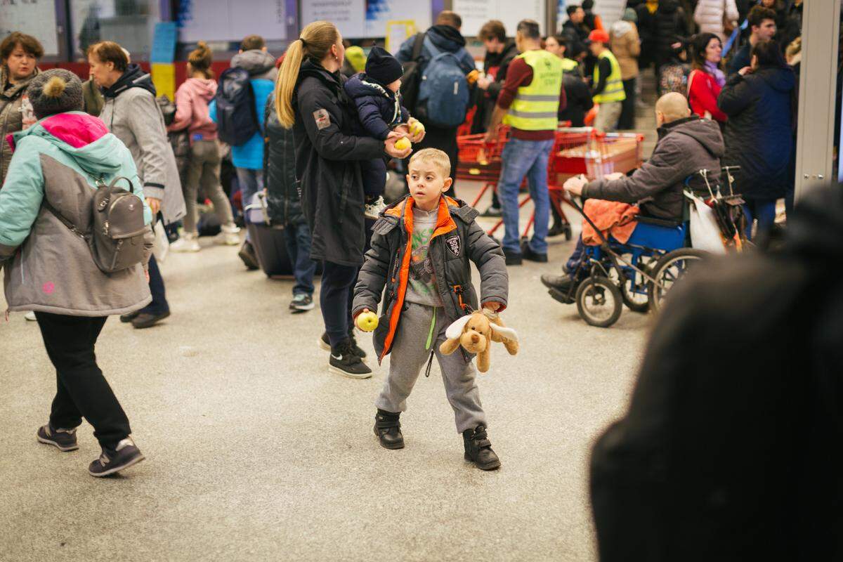 Ukrainian families arrive at a train station in Krakow, Poland, on March 9 after fleeing their home country in this photo taken by Avel Chuklanov.