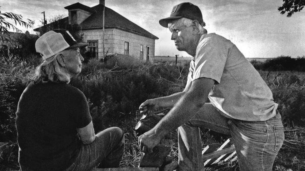 Hanford downwinder Tom Bailie sits with his mother, Laura Lee Bailie, at one of the old family homes in the Hanford area. Three generations of their family worked farmland around the Hanford Nuclear Reservation dating back to the 1940s and ‘50s. In 1990, they first learned of the U.S. Government exposing them to plutonium and other radioactive material from the development of the atomic bomb. The Bailie family was one of the largest landowners in the area during the ‘40s and ‘50s, and he feels they were heavily dosed with radiation from the Hanford plutonium factories.