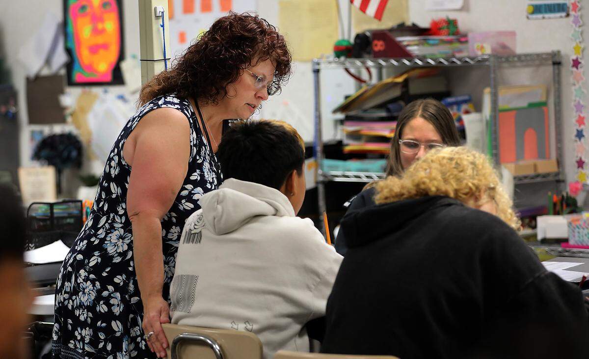 Teacher Francine Hicks helps her eighth-grade students with an assignment in her English and history class at Park Middle School in Kennewick.